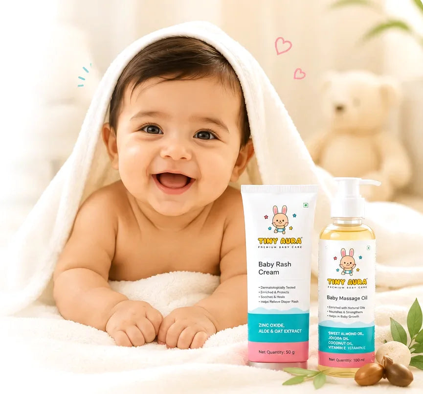 Smiling baby in a towel with Tiny Aura products